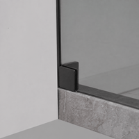 Bottom wall bracket detail on Jade matte black frameless shower door