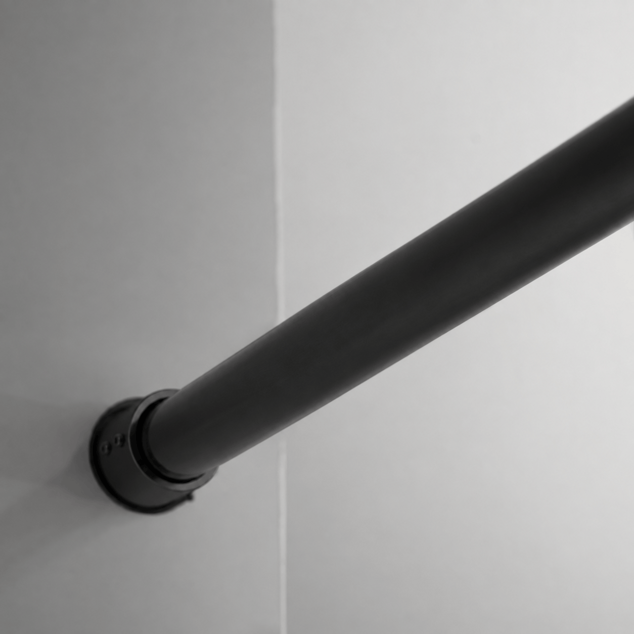 Wall-mounted stainless steel top track on Jade matte black sliding shower door