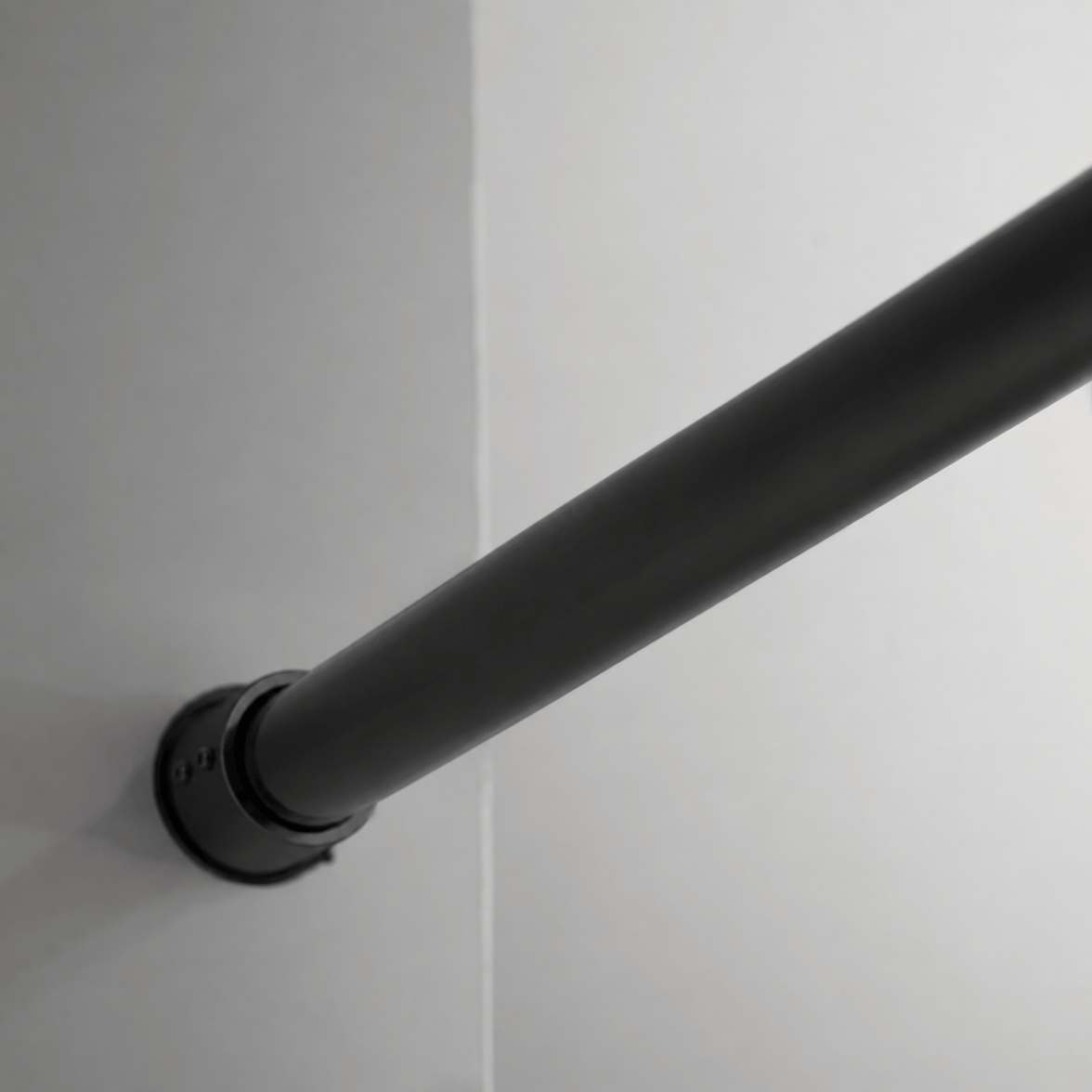 Wall-mounted stainless steel top track on Jade matte black sliding shower door